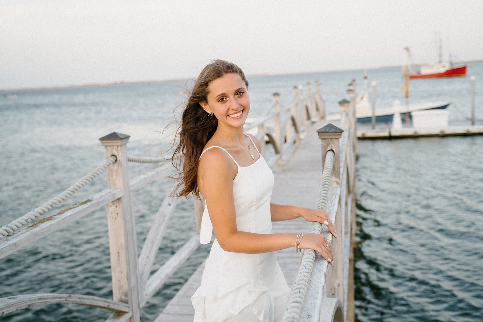 high school senior picture of a girl on a cape cod pier